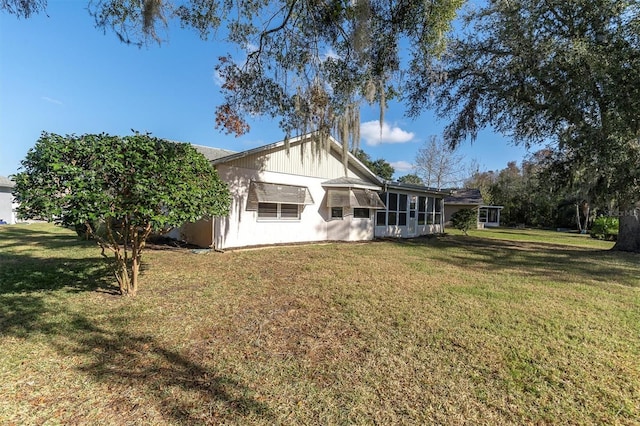 rear view of property featuring a yard