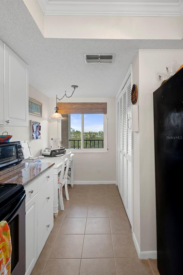 kitchen with black appliances, white cabinets, pendant lighting, and light tile patterned floors