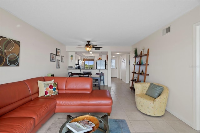 living room featuring ceiling fan and light tile patterned flooring