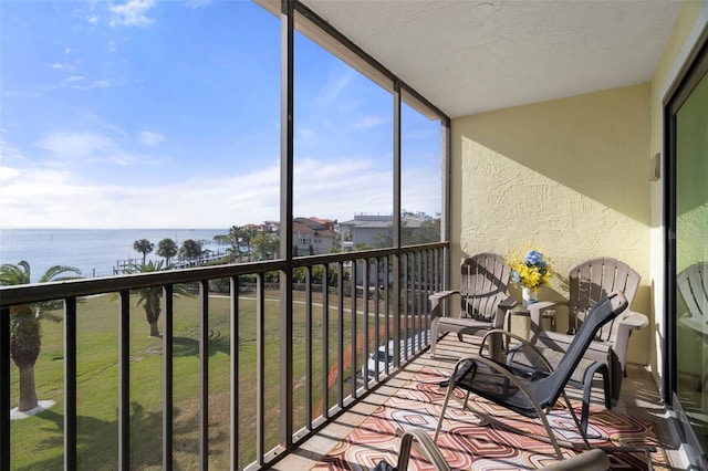 sunroom / solarium with a water view