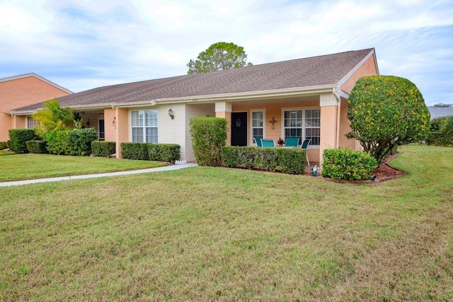 ranch-style home with a front lawn and stucco siding