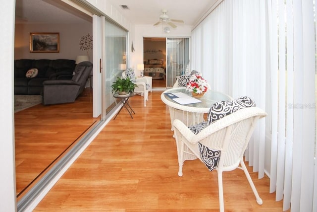 hall with light wood finished floors and visible vents