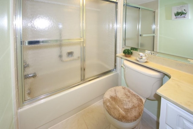 bathroom featuring enclosed tub / shower combo, vanity, and toilet