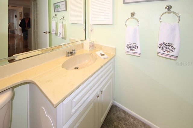 bathroom featuring baseboards and vanity