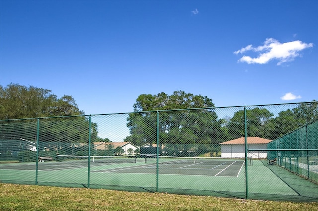 view of sport court featuring fence