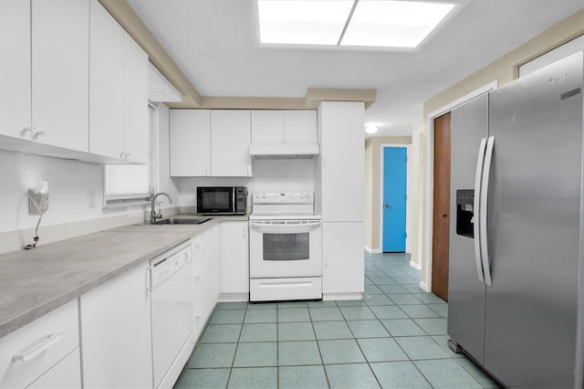 kitchen featuring sink, white cabinets, light tile patterned flooring, and white appliances