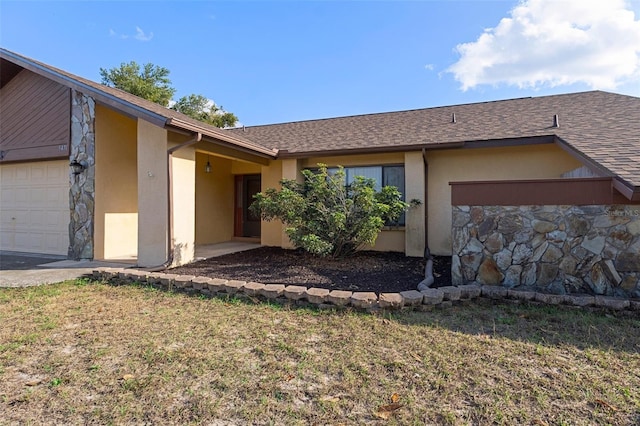 view of front of property with a front yard and a garage