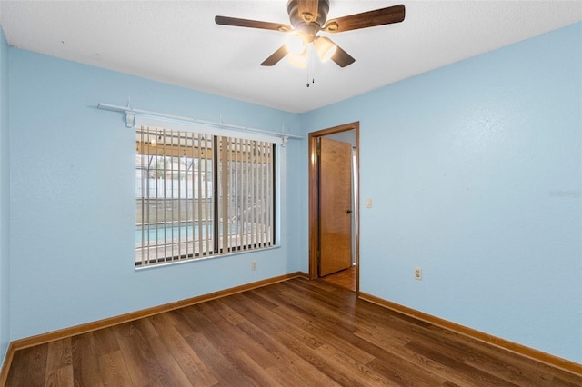 spare room featuring ceiling fan and hardwood / wood-style flooring