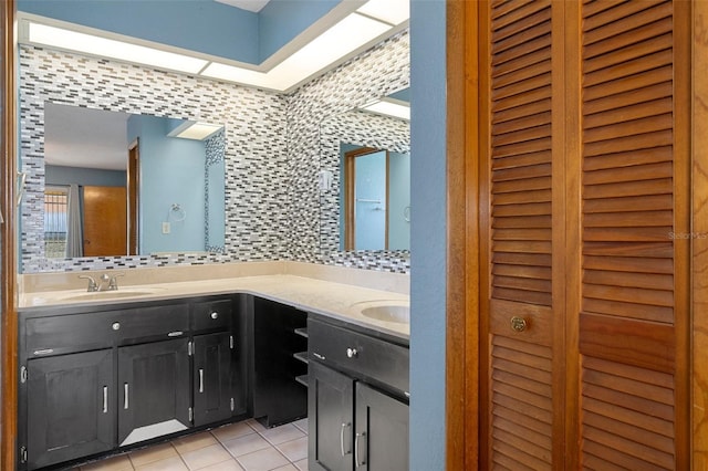 bathroom featuring tile patterned floors, vanity, and tasteful backsplash