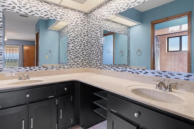 bathroom with tile patterned floors, decorative backsplash, and vanity