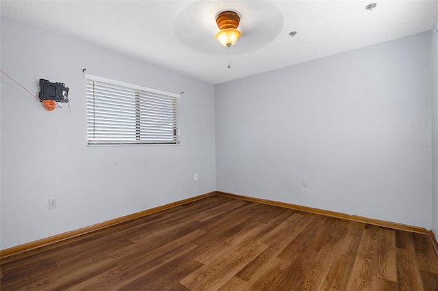 unfurnished room with ceiling fan and hardwood / wood-style floors