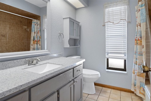 bathroom with toilet, vanity, tile patterned floors, and a shower with shower curtain