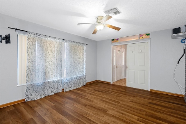 unfurnished bedroom with ceiling fan, wood-type flooring, a textured ceiling, and a closet