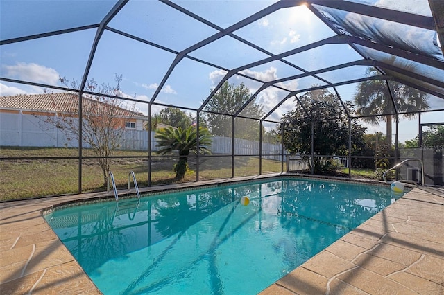 view of pool featuring glass enclosure and a patio area