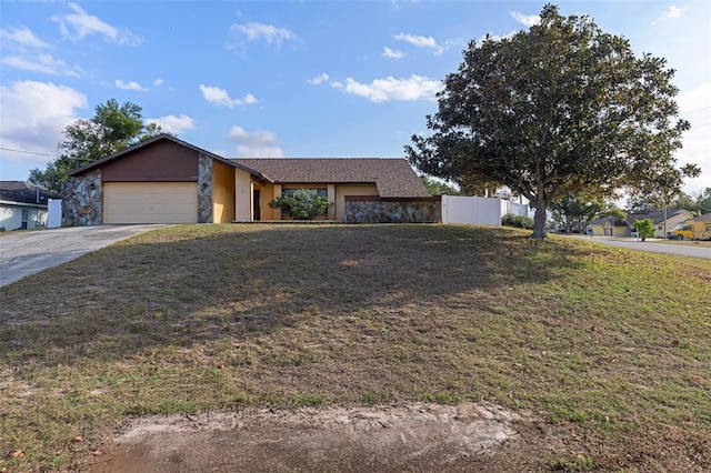 ranch-style home featuring a front yard and a garage