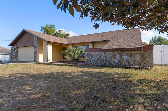 single story home with a front lawn and a garage