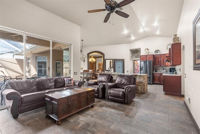 14101 Andrew Scott Rd, Spring Hill, FL 34609 - living room featuring lofted ceiling, ceiling fan, a chandelier, and arched walkways