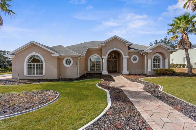 14101 Andrew Scott Rd, Spring Hill, FL 34609 - mediterranean / spanish-style house with stucco siding and a front lawn