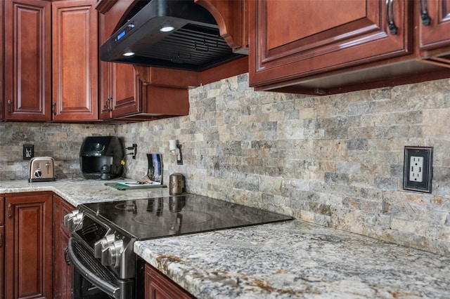 14101 Andrew Scott Rd, Spring Hill, FL 34609 - kitchen featuring electric range, ventilation hood, decorative backsplash, light stone counters, and reddish brown cabinets