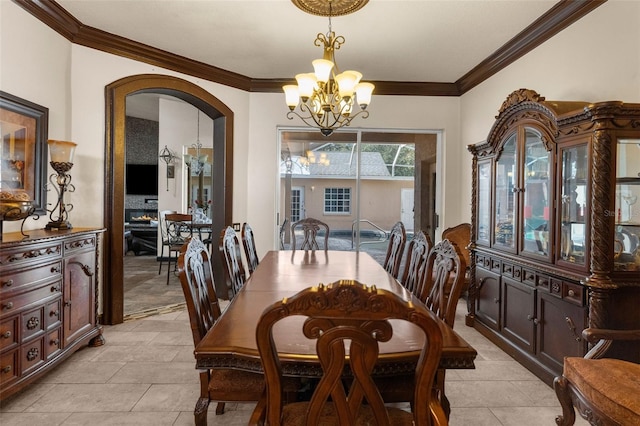 14101 Andrew Scott Rd, Spring Hill, FL 34609 - dining room with a chandelier, arched walkways, ornamental molding, and light tile patterned flooring