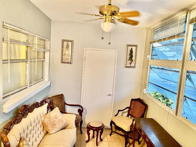 living area featuring ceiling fan and light tile patterned floors