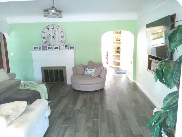 living area featuring arched walkways, a fireplace, ornamental molding, wood tiled floor, and baseboards