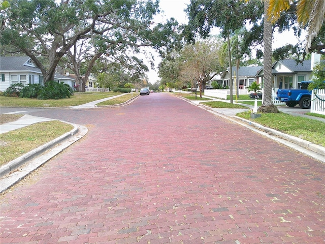 view of road with curbs, sidewalks, and a residential view