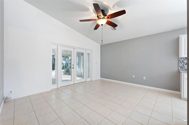 tiled spare room with french doors, vaulted ceiling, and ceiling fan