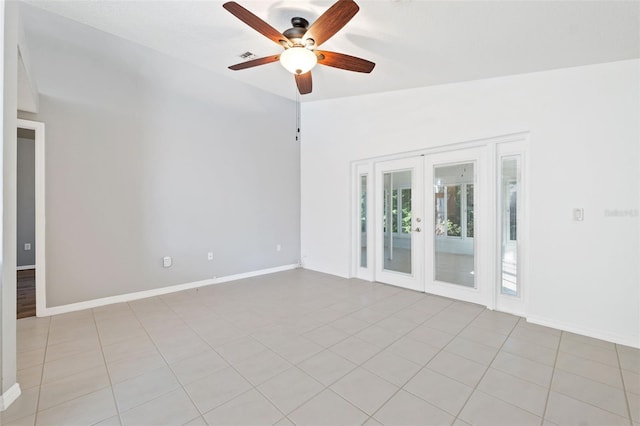 tiled spare room with ceiling fan, lofted ceiling, and french doors