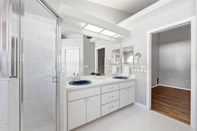 bathroom with vanity, tile patterned floors, and a shower with shower door