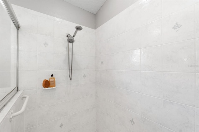 bathroom with tiled shower