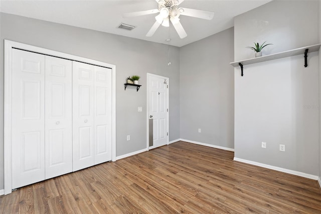 unfurnished bedroom with ceiling fan, wood-type flooring, and vaulted ceiling