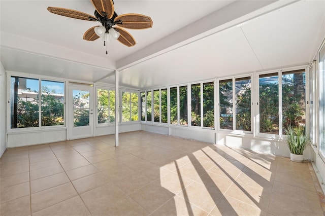 unfurnished sunroom featuring ceiling fan and plenty of natural light