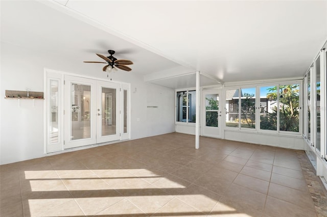 unfurnished sunroom with ceiling fan