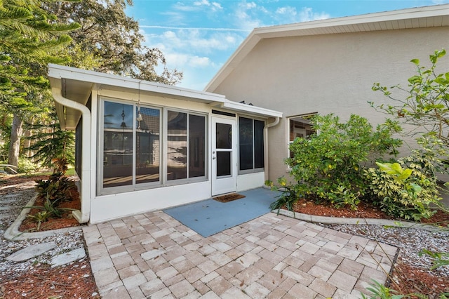 exterior space featuring a sunroom and a patio