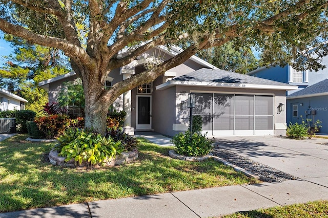 view of front of home with a front lawn and a garage