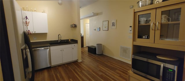 kitchen with white cabinets, dark hardwood / wood-style flooring, sink, and appliances with stainless steel finishes