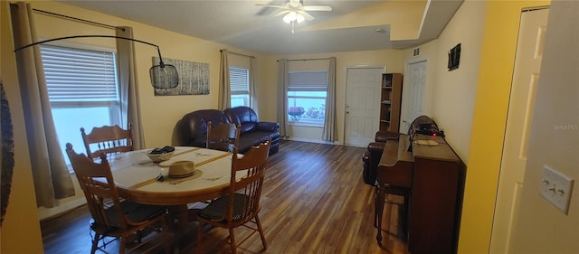 dining area featuring a textured ceiling, dark hardwood / wood-style floors, and ceiling fan