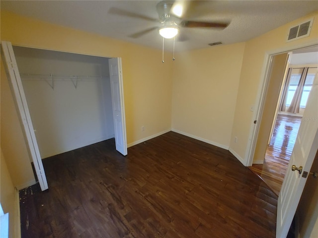 unfurnished bedroom with a closet, ceiling fan, and dark hardwood / wood-style floors