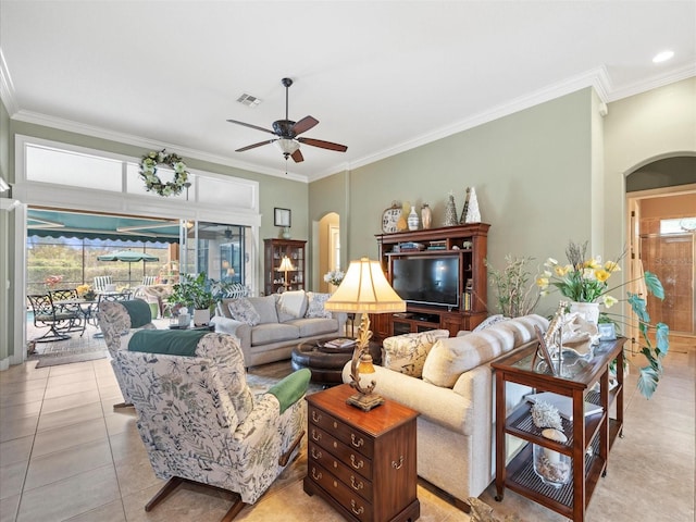 living room with ceiling fan, light tile patterned floors, and ornamental molding