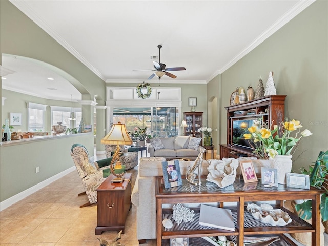 tiled living room with ceiling fan and crown molding