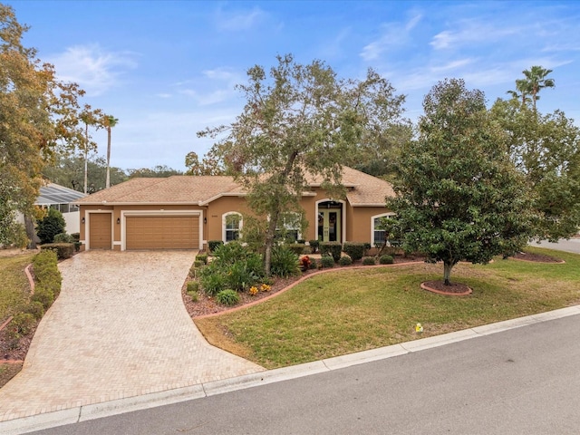 view of front of house featuring a front yard and a garage