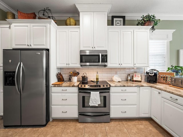 kitchen featuring white cabinetry, stainless steel appliances, light stone counters, crown molding, and decorative backsplash