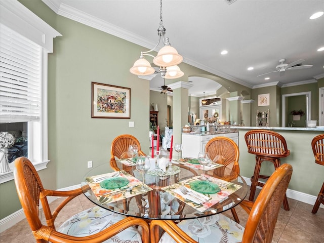 dining area featuring ceiling fan with notable chandelier, light tile patterned flooring, crown molding, and a wealth of natural light