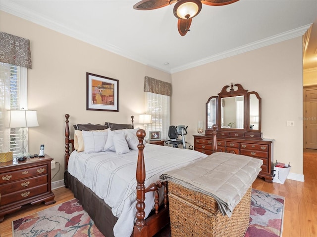 bedroom featuring ceiling fan, light hardwood / wood-style flooring, and ornamental molding