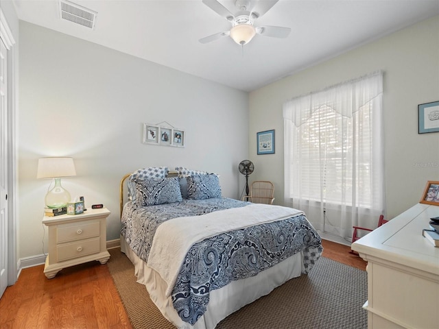 bedroom with ceiling fan and hardwood / wood-style floors