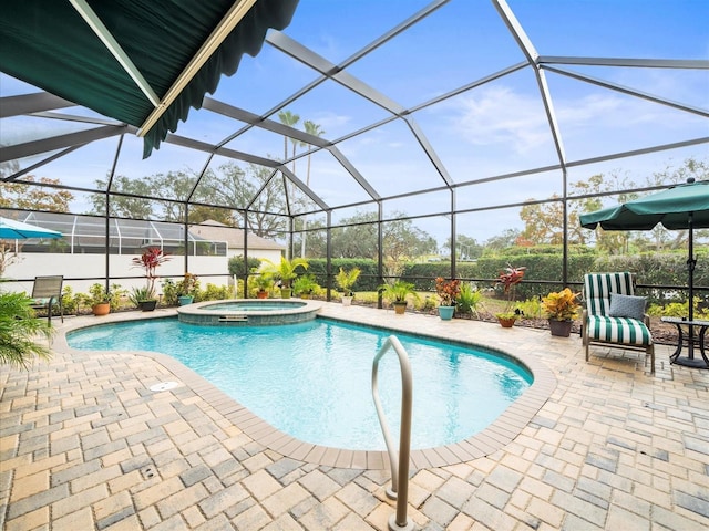 view of pool featuring glass enclosure, a patio area, and an in ground hot tub