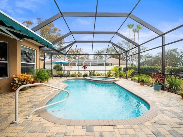 view of swimming pool featuring glass enclosure, an in ground hot tub, and a patio