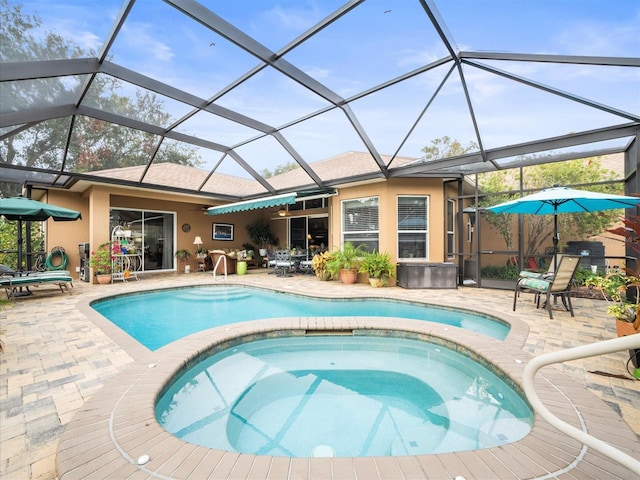 view of swimming pool with an in ground hot tub, glass enclosure, and a patio area