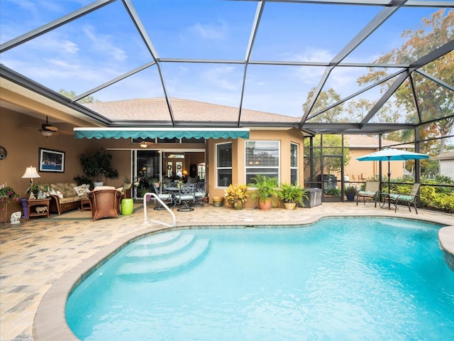 view of pool with ceiling fan, a patio area, an outdoor living space, and glass enclosure